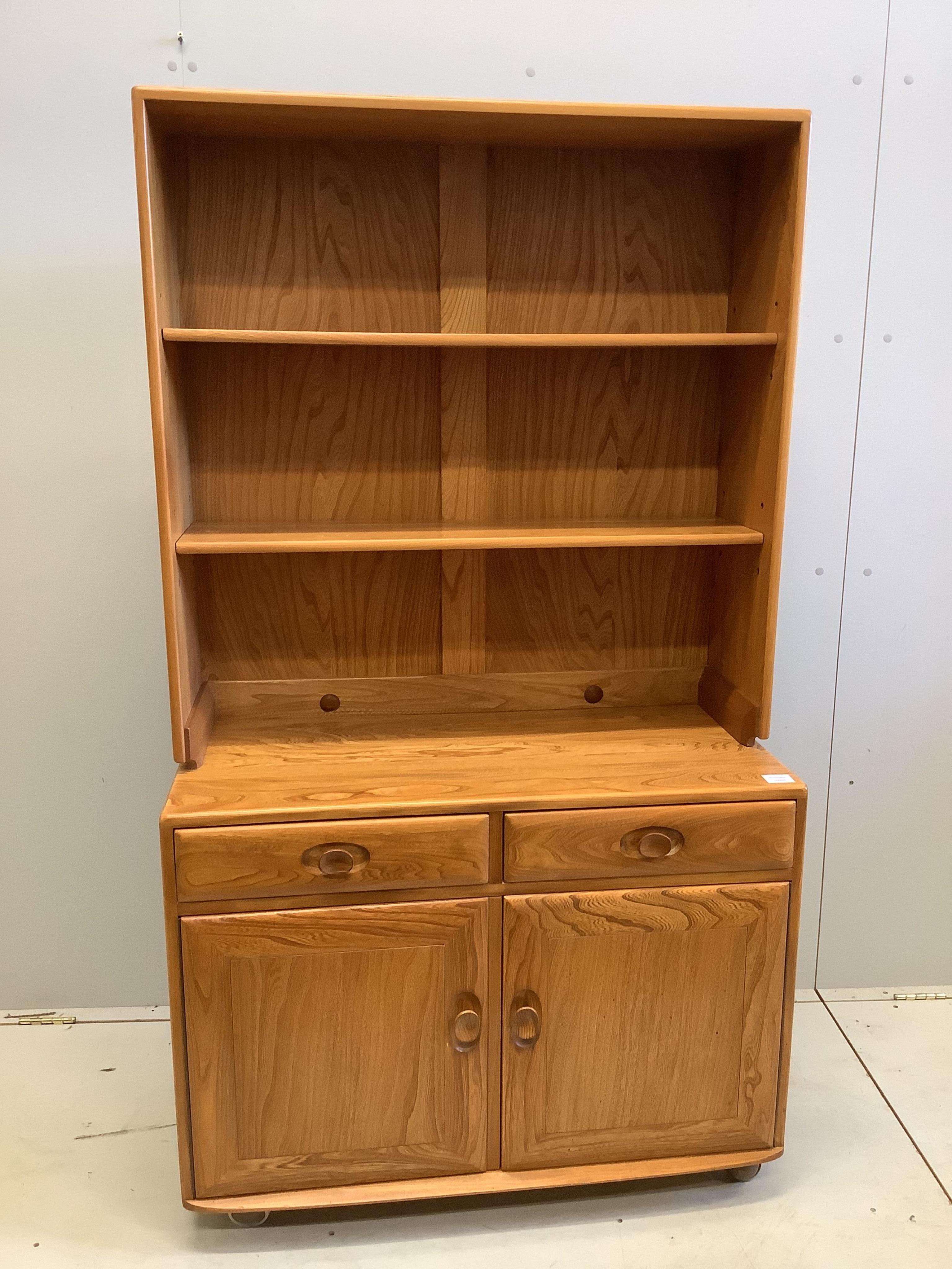 An Ercol Windsor elm side cabinet, width 91cm, depth 43cm, height 160cm. Condition - good